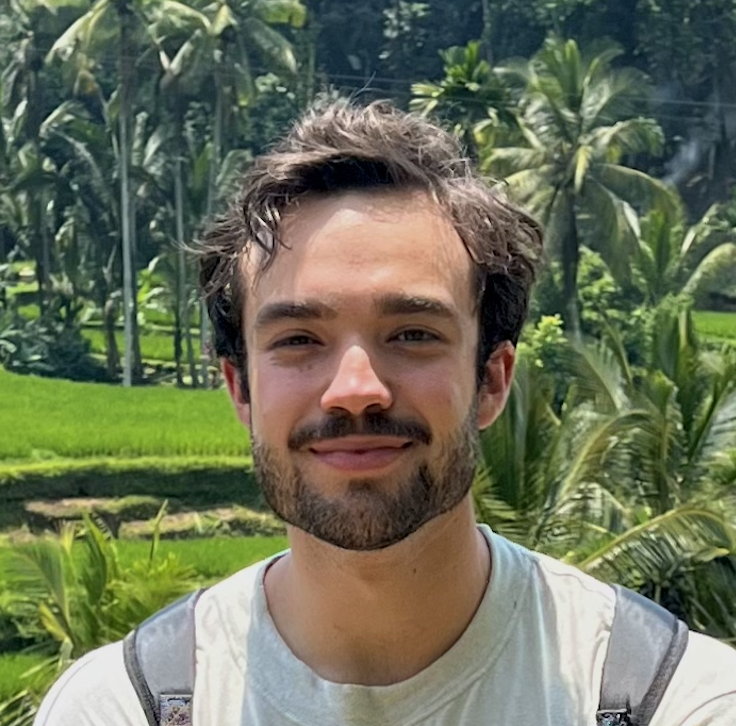 Emilio Villa-Cueva smiling, wearing a formal shirt